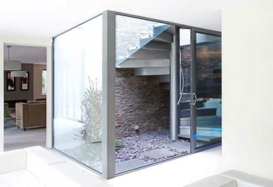 Internal glass 'box' housing staircase to external terrace in refurbished house in Cheltenham
