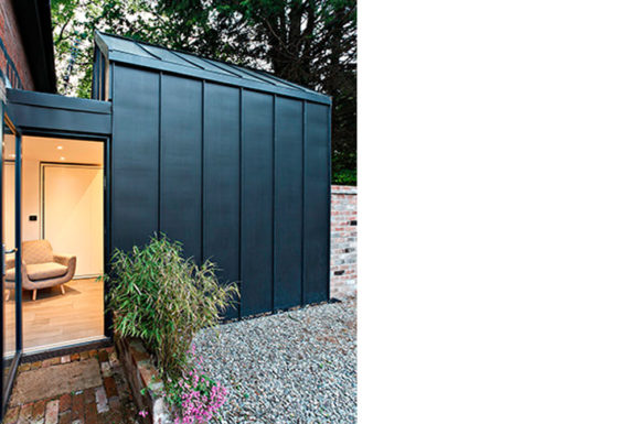 A contemporary extension to a small coach house.